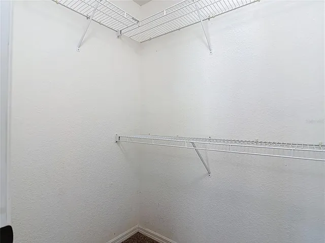 an empty room with a fan and a fan