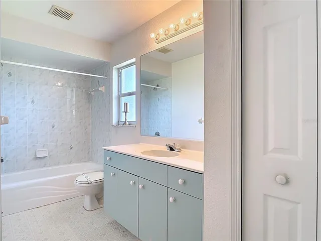 a bedroom with a bed closet and a window