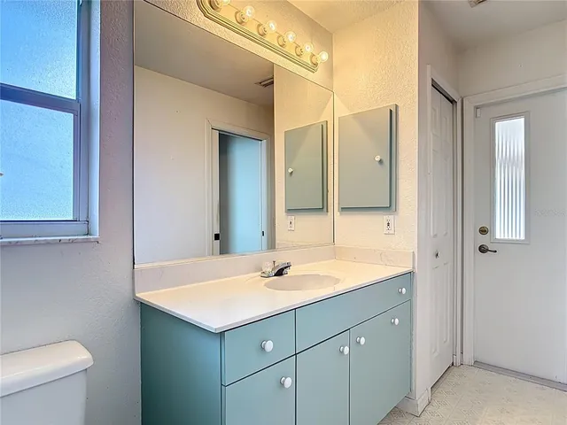 a bedroom with a bed and a lamp