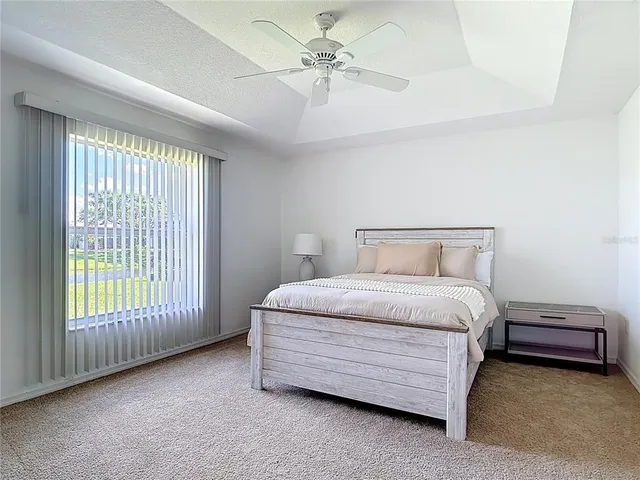 a bedroom with a large bed and a chandelier