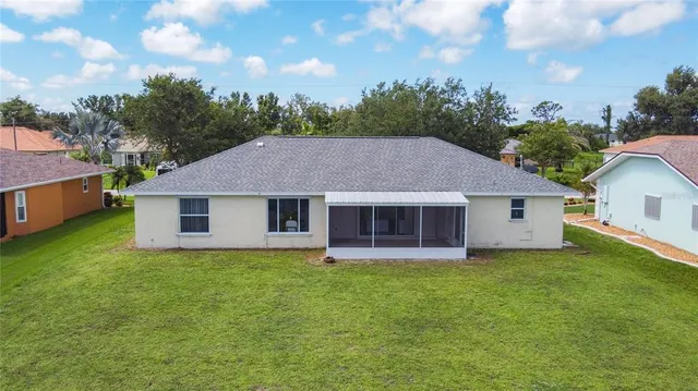 an aerial view of residential houses with outdoor space and swimming pool