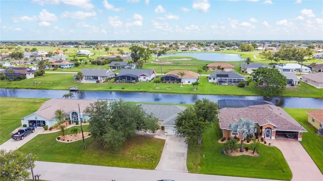 an aerial view of a house with a swimming pool yard and outdoor seating