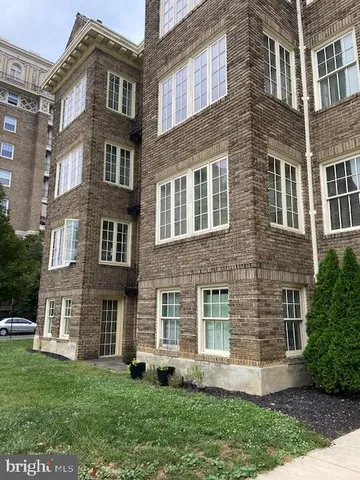 a view of a brick building next to a yard