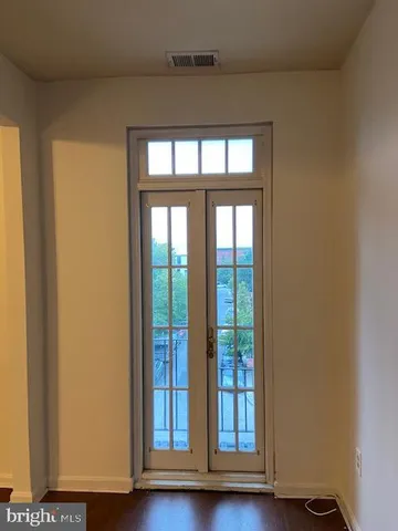 a view of wooden floor and chandelier in a room