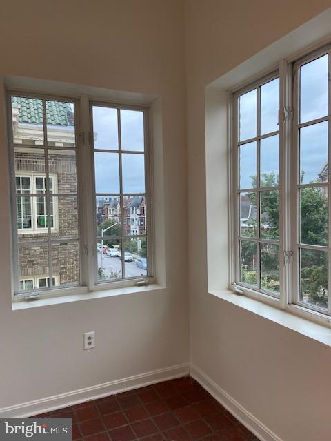 2511 Eutaw Place, Unit 402 Baltimore, MD 21217 - Photo 16 of 18 wooden floor and window in an empty room