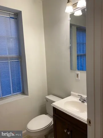 a bathroom with a sink a toilet and mirror