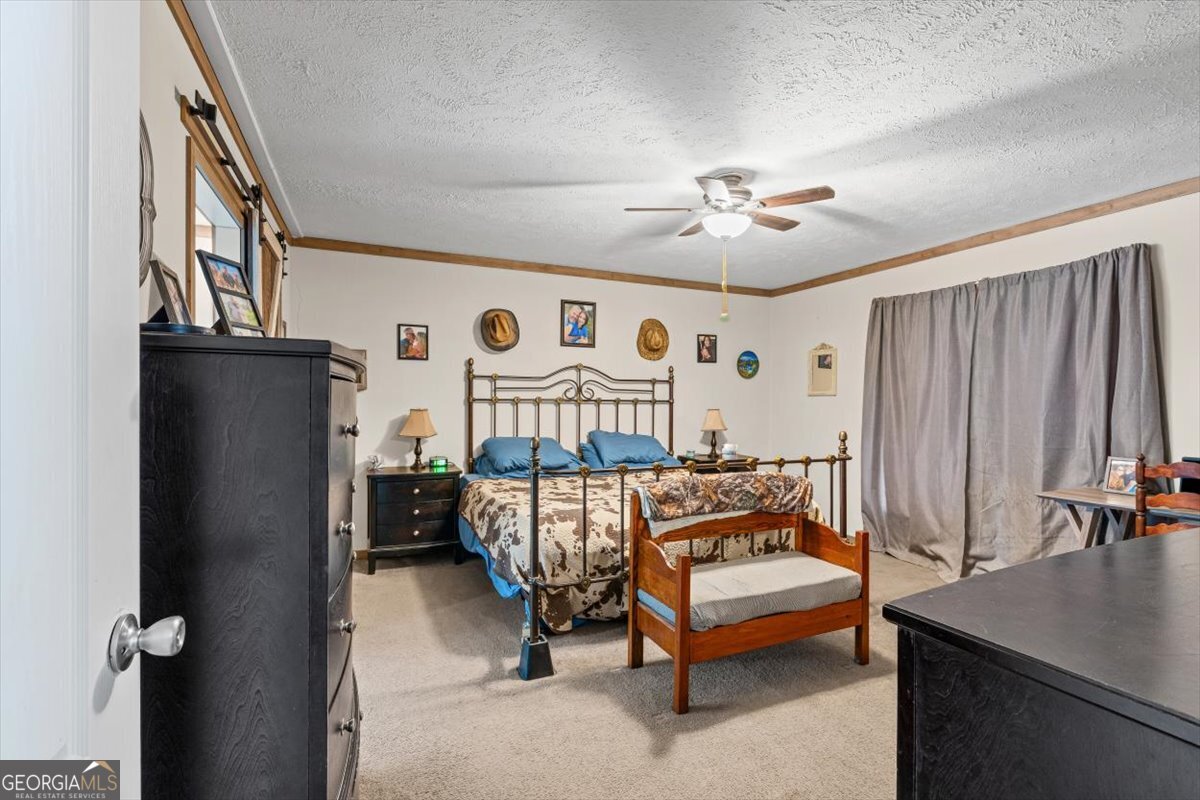 152 Campbell Road Cedartown, GA 30125 - Photo 12 of 42 a bedroom with furniture and a chandelier fan