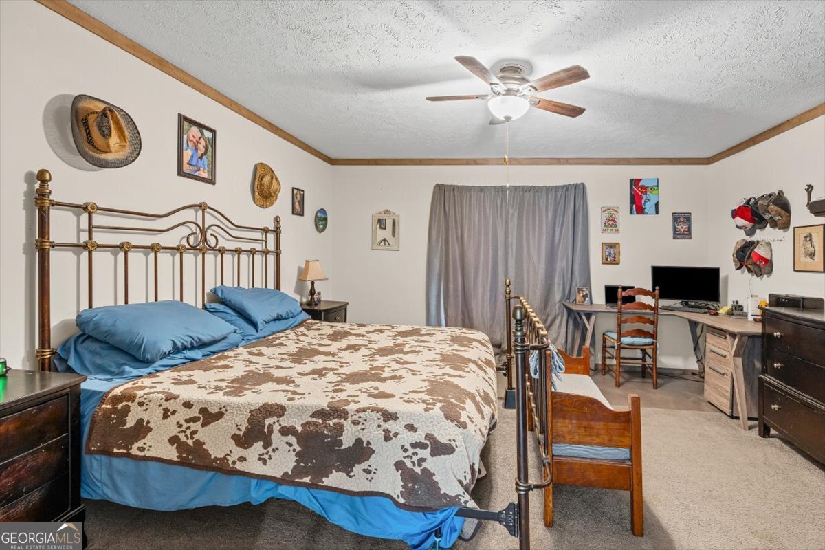 152 Campbell Road Cedartown, GA 30125 - Photo 13 of 42 a bedroom with a bed and a table in it