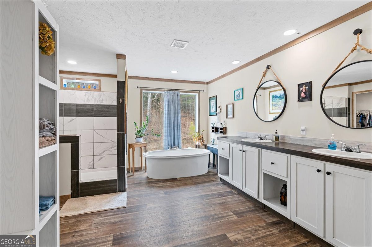 152 Campbell Road Cedartown, GA 30125 - Photo 14 of 42 a spacious bathroom with a double vanity sink and a mirror
