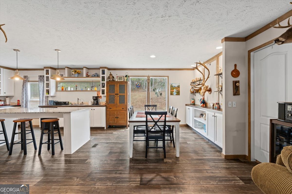 152 Campbell Road Cedartown, GA 30125 - Photo 17 of 42 a kitchen with a table chairs refrigerator and cabinets