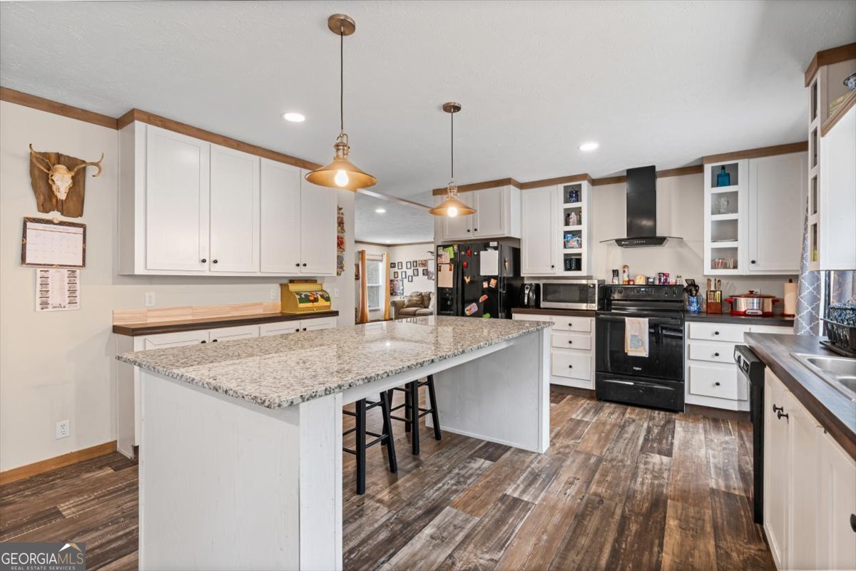 152 Campbell Road Cedartown, GA 30125 - Photo 24 of 42 a kitchen with stainless steel appliances granite countertop a stove top oven a sink dishwasher and white cabinets with wooden floor