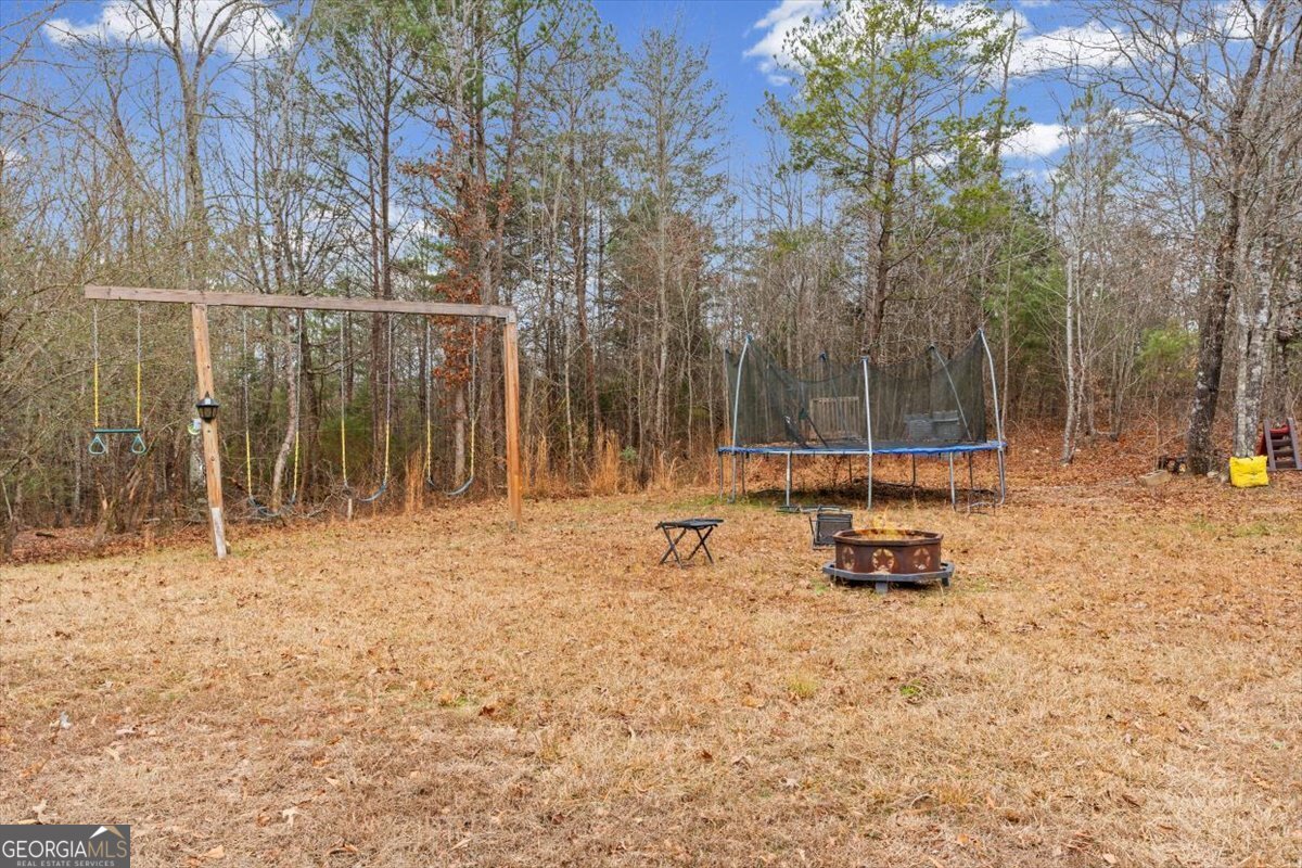 152 Campbell Road Cedartown, GA 30125 - Photo 38 of 42 a backyard of a house with lots of green space and fountain
