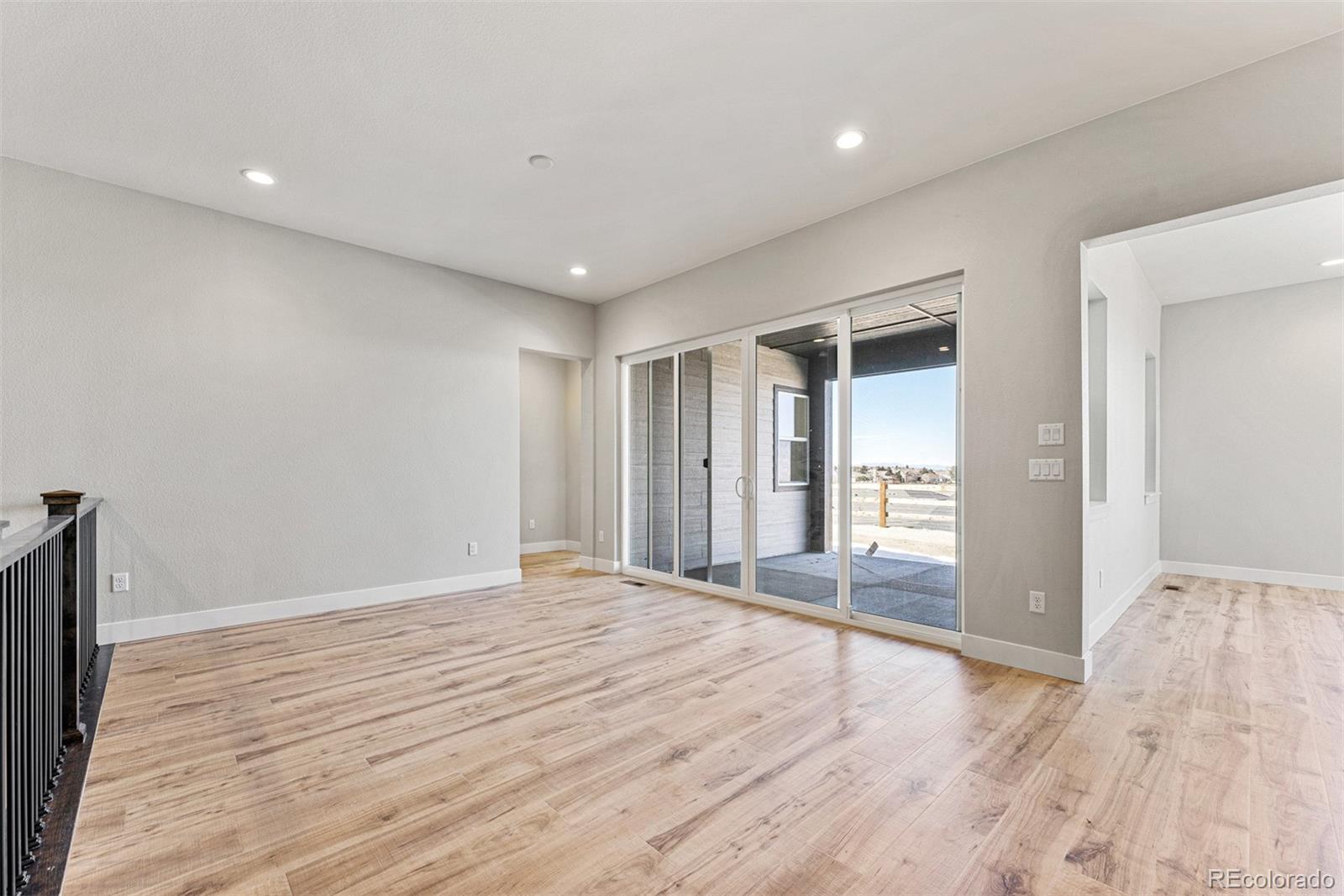 75 Clara Place Castle Pines, CO 80108 - Photo 12 of 39 a view of empty room with wooden floor