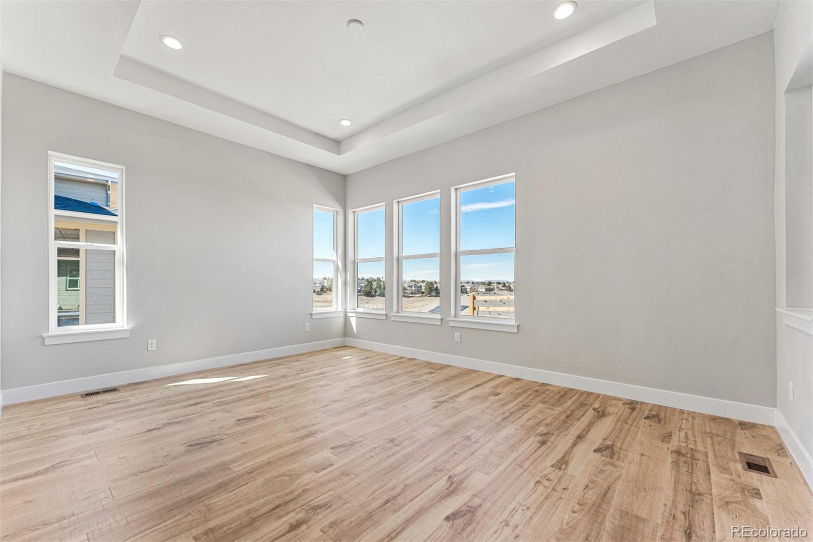 75 Clara Place Castle Pines, CO 80108 - Photo 15 of 39 a view of an empty room with wooden floor and a window