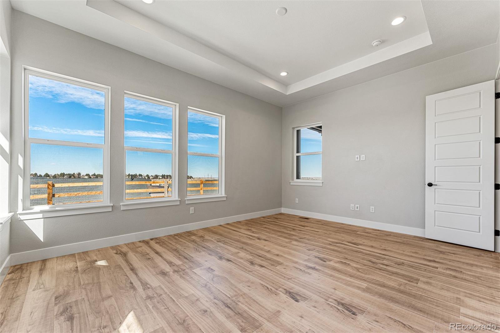 75 Clara Place Castle Pines, CO 80108 - Photo 16 of 39 a view of an empty room with a window and wooden floor