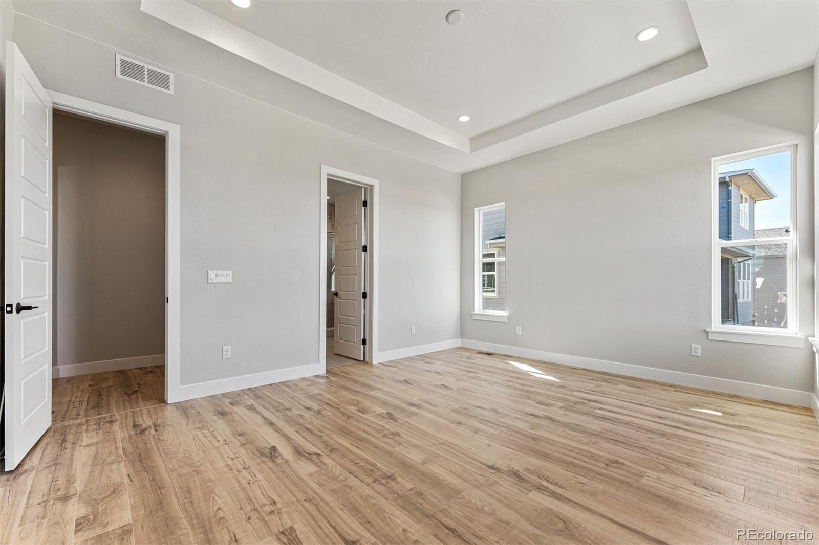 75 Clara Place Castle Pines, CO 80108 - Photo 17 of 39 a view of an empty room with wooden floor and windows