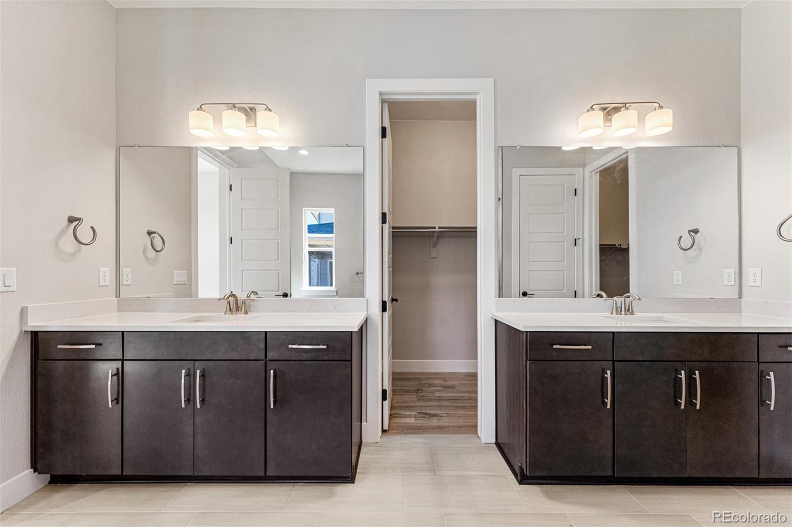 75 Clara Place Castle Pines, CO 80108 - Photo 18 of 39 a bathroom with a sink double vanity and a mirror