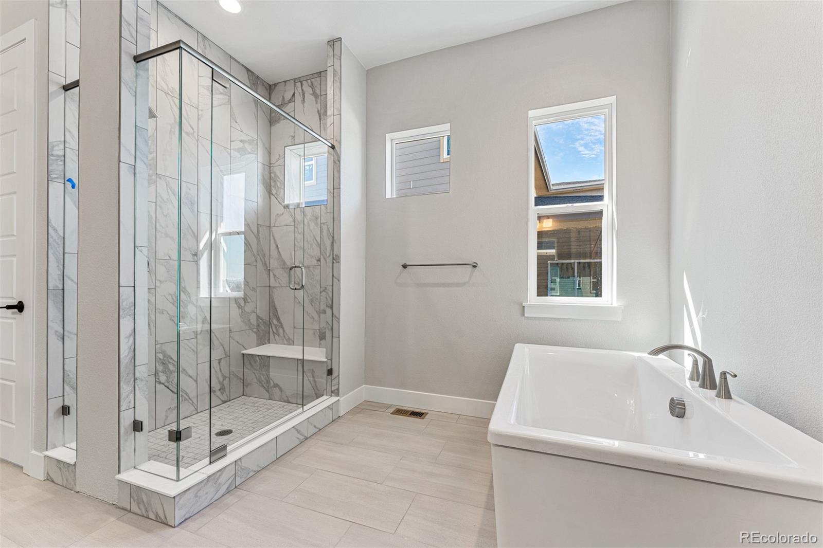 75 Clara Place Castle Pines, CO 80108 - Photo 20 of 39 a bathroom with a tub shower and sink
