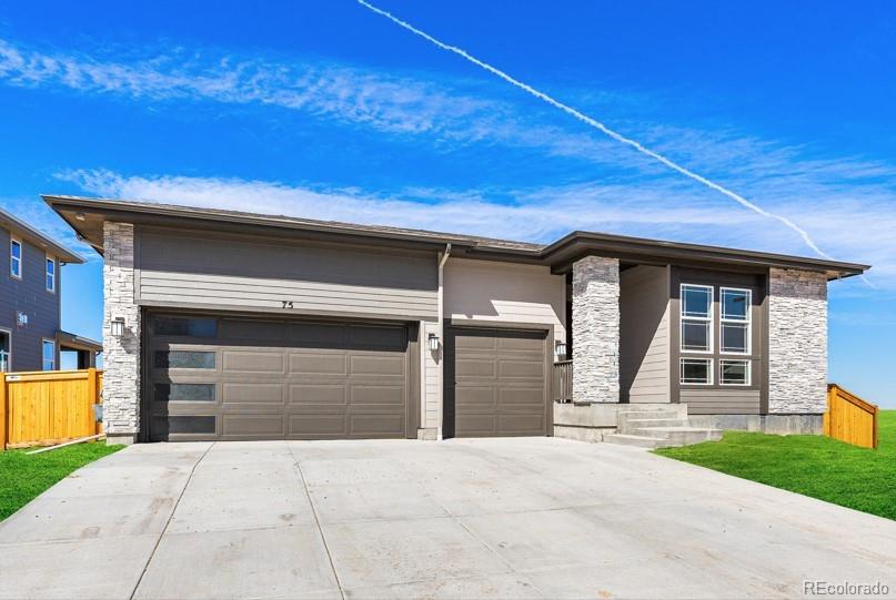 75 Clara Place Castle Pines, CO 80108 - Photo 2 of 39 a front view of a house with a yard and garage