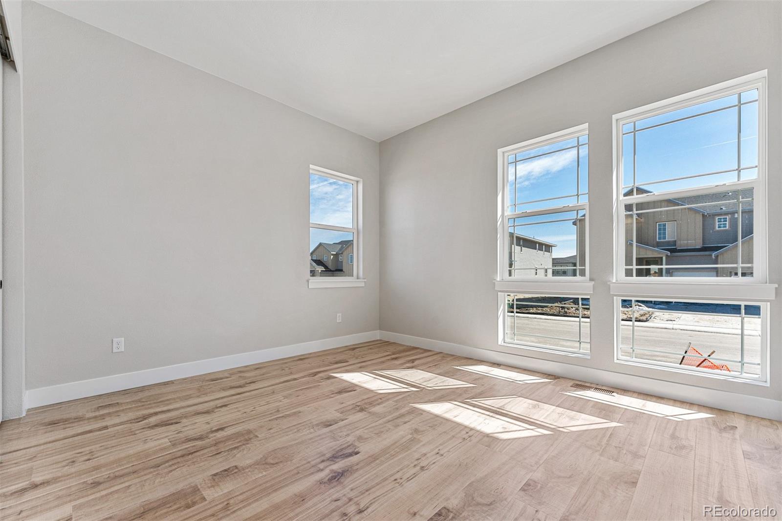 75 Clara Place Castle Pines, CO 80108 - Photo 27 of 39 a view of an empty room with a window and wooden floor