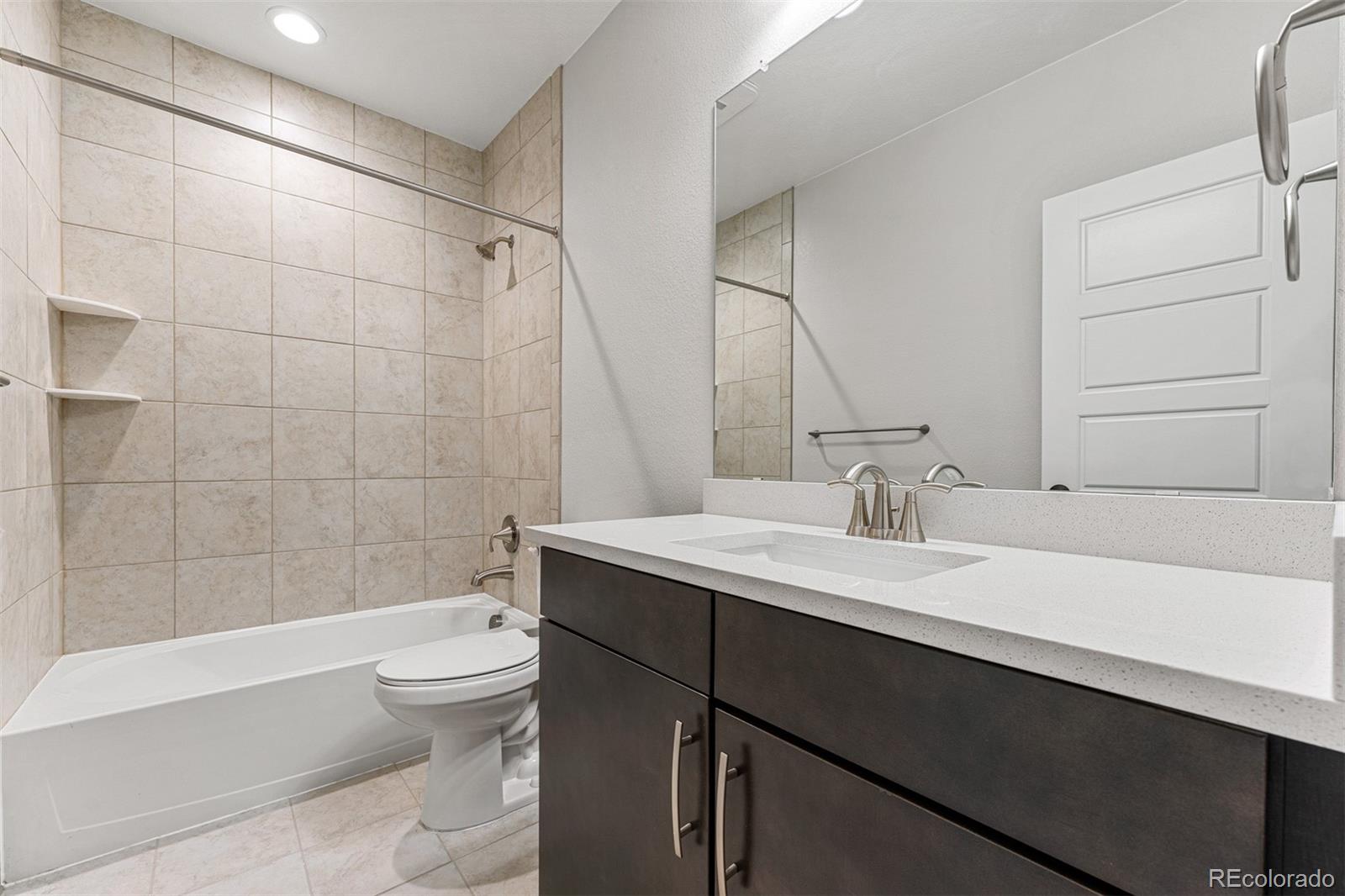 75 Clara Place Castle Pines, CO 80108 - Photo 36 of 39 a bathroom with a sink a toilet and shower