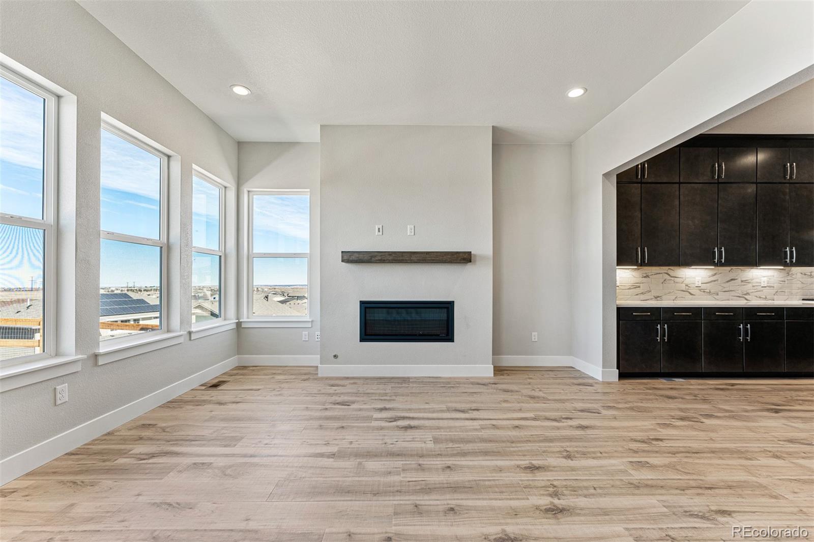 75 Clara Place Castle Pines, CO 80108 - Photo 8 of 39 a view of an empty room with a fireplace and a window