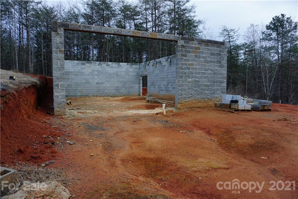 2312 Owl Hollow Road Mill Spring, NC 28756 - Photo 2 of 22 a backyard of a house with table and chairs