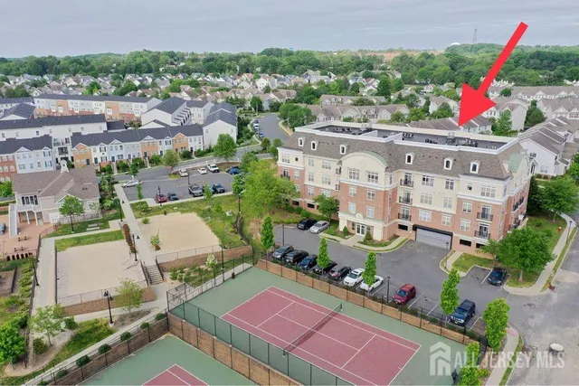 an aerial view of a house with a swimming pool patio and outdoor seating