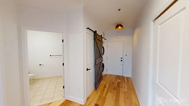 a view of hallway with wooden floor