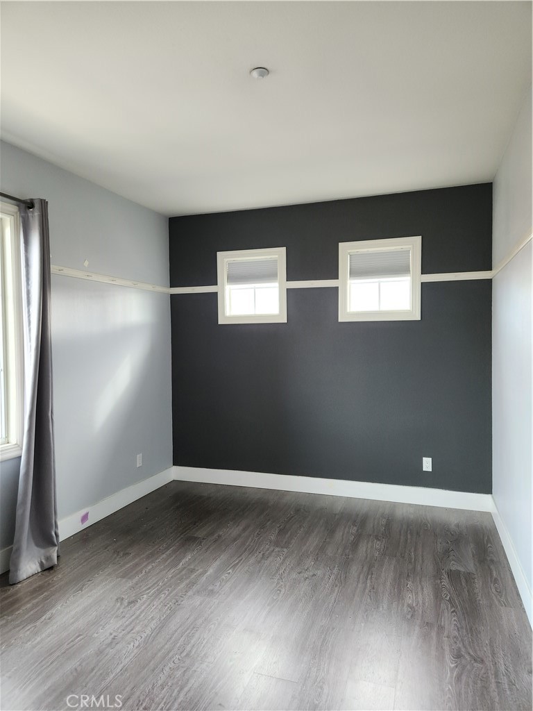 4540 Springleaf Lane Riverside, CA 92505 - Photo 13 of 32 an empty room with wooden floor and windows