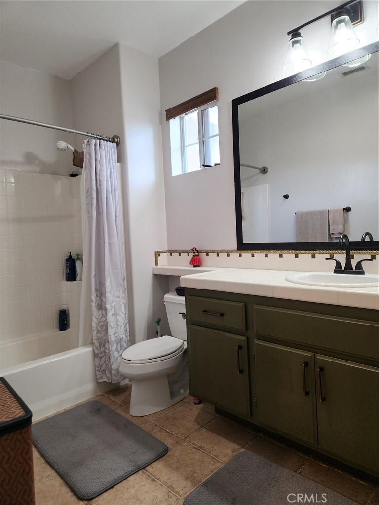 4540 Springleaf Lane Riverside, CA 92505 - Photo 15 of 32 a bathroom with a sink toilet and shower
