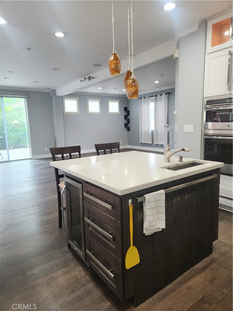 4540 Springleaf Lane Riverside, CA 92505 - Photo 19 of 32 a kitchen with stainless steel appliances granite countertop a sink a stove and a wooden floors