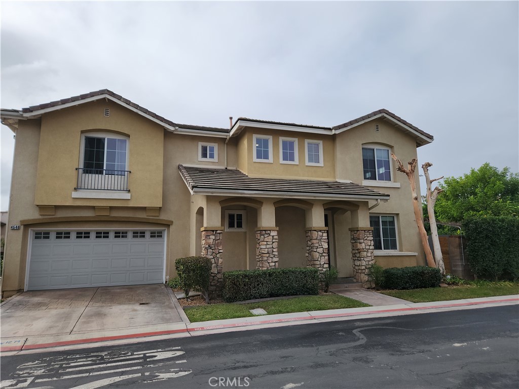 4540 Springleaf Lane Riverside, CA 92505 - Photo 2 of 32 a front view of a house with a yard and garage