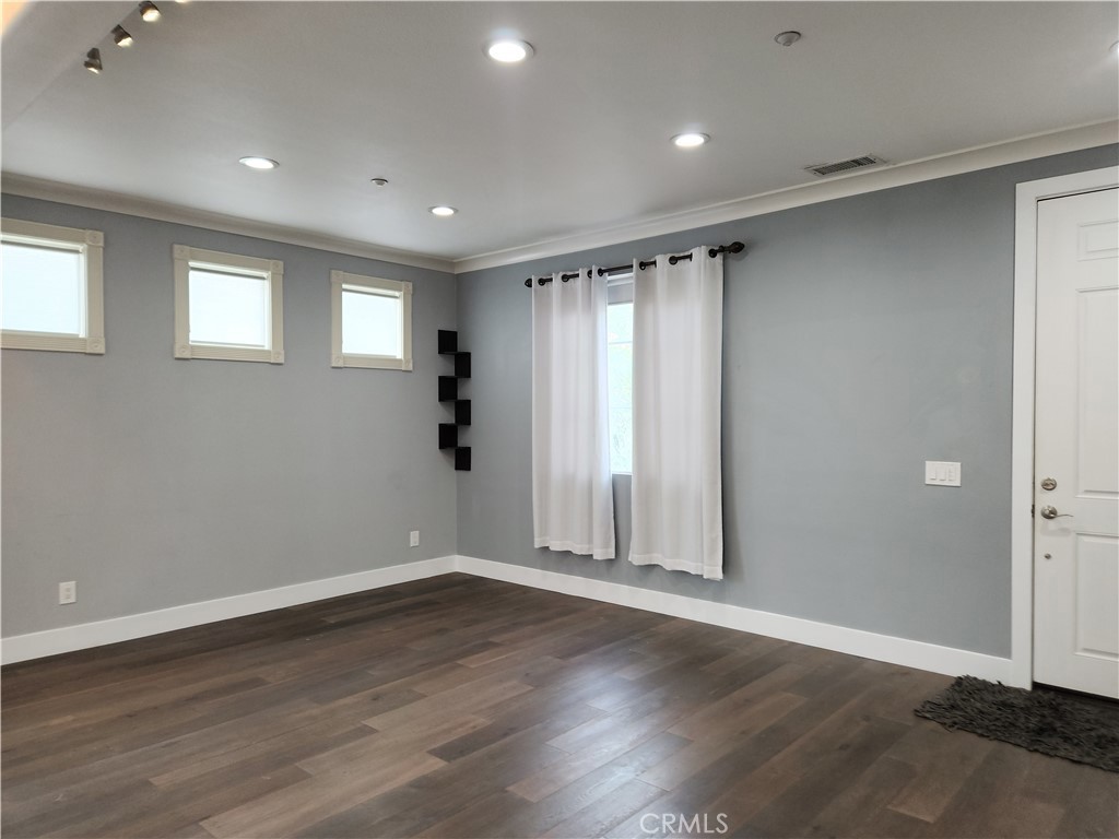 4540 Springleaf Lane Riverside, CA 92505 - Photo 32 of 32 an empty room with wooden floor and windows