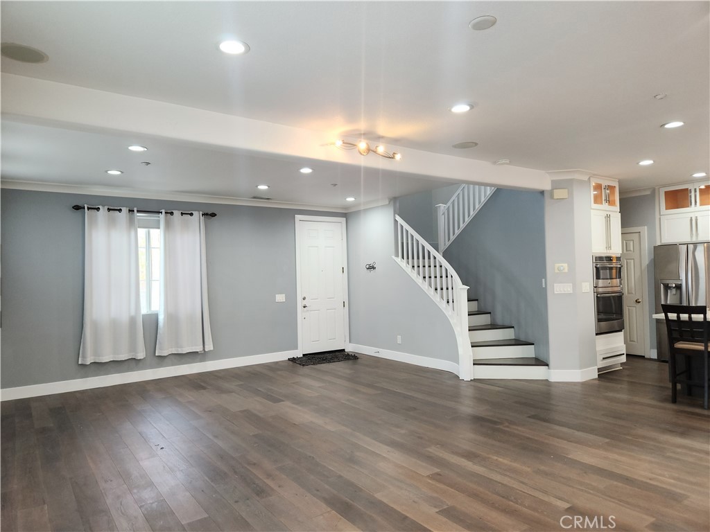 4540 Springleaf Lane Riverside, CA 92505 - Photo 5 of 32 an empty room with wooden floor and windows