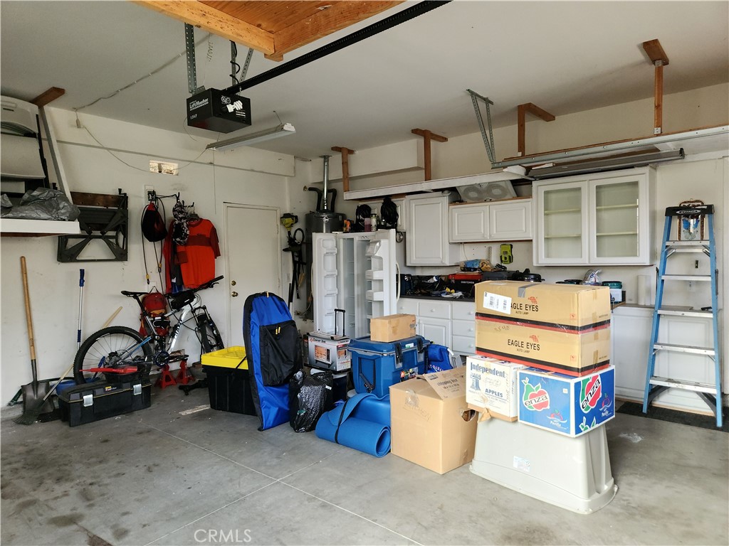 4540 Springleaf Lane Riverside, CA 92505 - Photo 8 of 32 a view of a storage room with water heater and racks