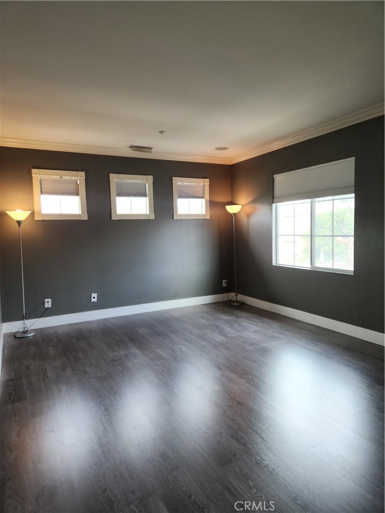 4540 Springleaf Lane Riverside, CA 92505 - Photo 9 of 32 an empty room with wooden floor and windows