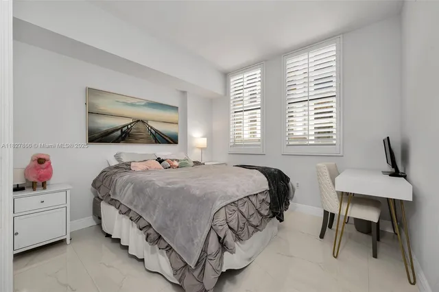 a bedroom with a bed and a dresser in it