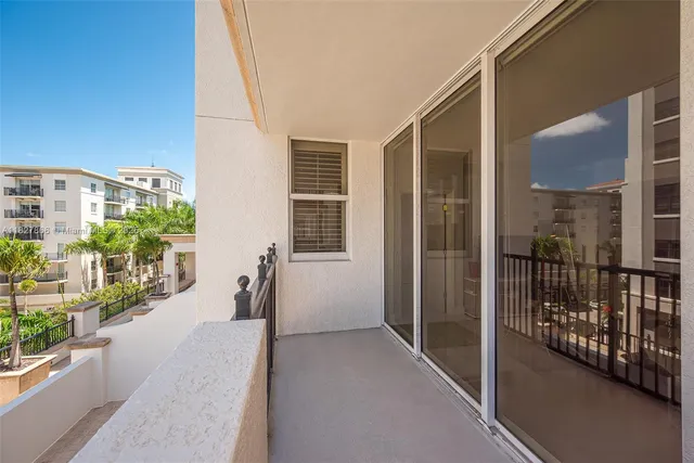 a view of a balcony with potted plants