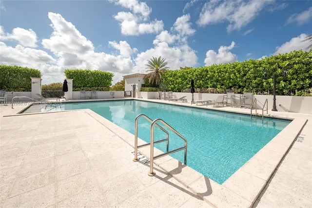a view of a swimming pool with a yard
