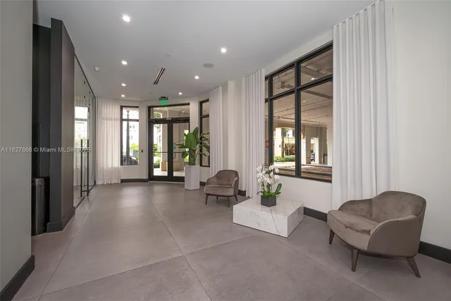 a lobby with furniture and floor to ceiling window