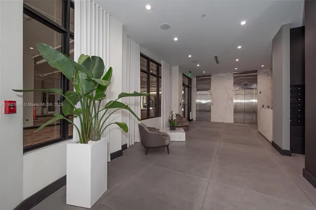 a view of entryway and hall with a potted plant