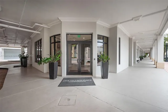 a view of a hallway with dining area and glass door