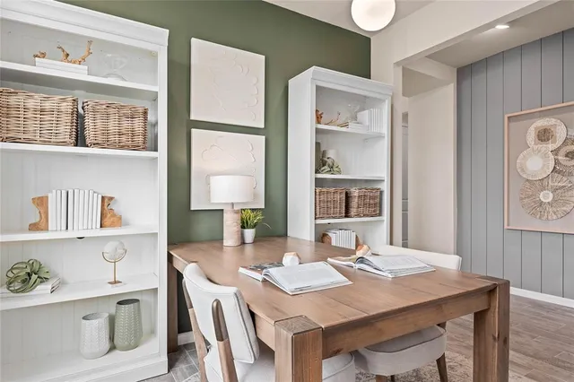 a view of a dining room with a table and chairs