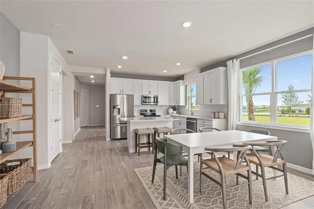 a view of a dining room with furniture and wooden floor