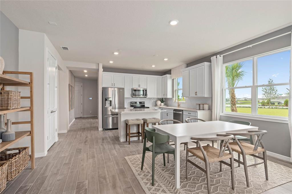 6300 Dew Drop Loop St. Cloud, FL 34771 - Photo 8 of 29 a view of a dining room with furniture and wooden floor