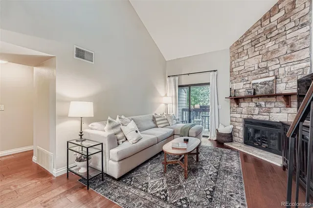 a living room with furniture a window and a fireplace