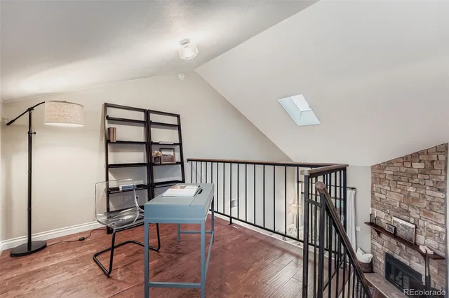 a workspace with furniture window and wooden floor