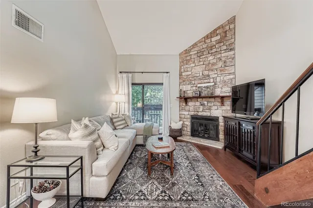 a living room with furniture a fireplace and a table