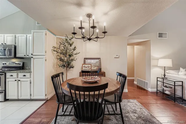 a view of a dining room with furniture and wooden floor